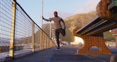 Man Stretching Before Workout on Ocean Boardwalk