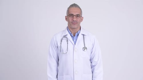 Doctor in White Coat Staring at the Camera