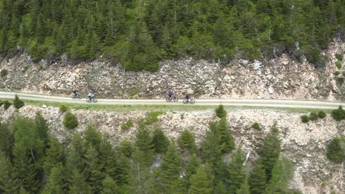 Cyclist group on cycling trip on mountain road in Moravia, drone shot.