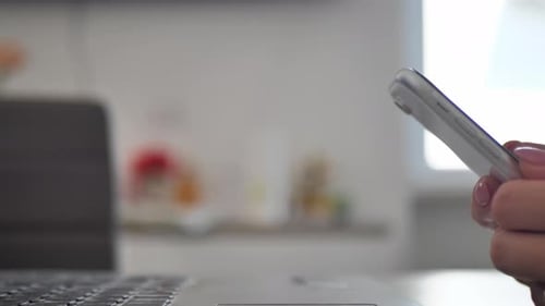 Businesswoman Sitting in Modern Office Texting on Smartphone Sharing Success Messages on Social