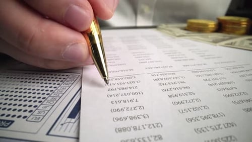 Accountant Analyzing Business Marketing Data on Paper Dashboard at Office Table