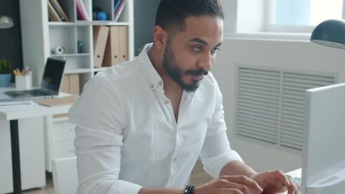Slow Motion of Elegant Mixed Race Man Office Worker Using Computer at Work