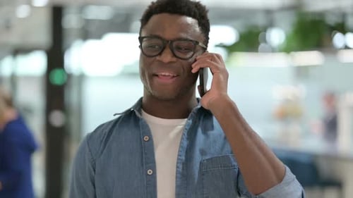 Young Adult Talking on Smartphone in Office