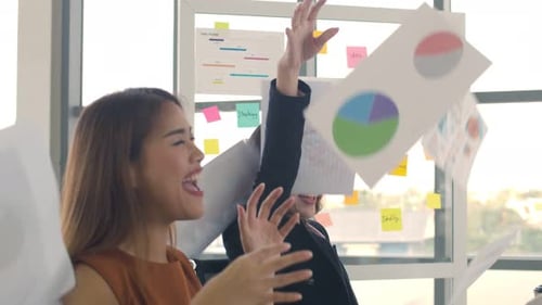 Happy Businesswomen Celebrating Success in Office