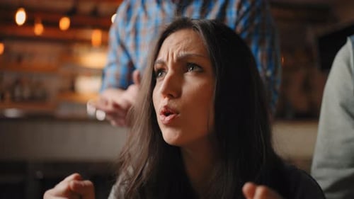 Excited Woman Cheers at Bar with Friends
