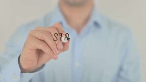 Man writes strategy and success on glass