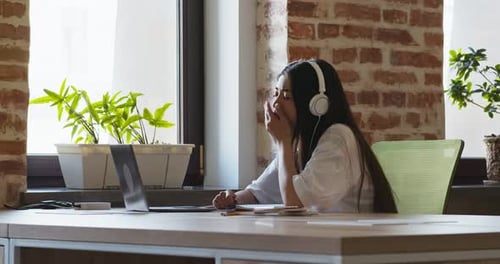 Young Woman Working At Desk With Laptop