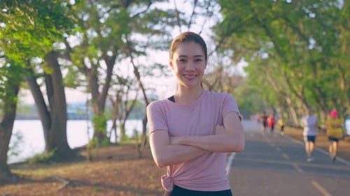 Asian active sport woman stand with confidence after exercise outdoors.