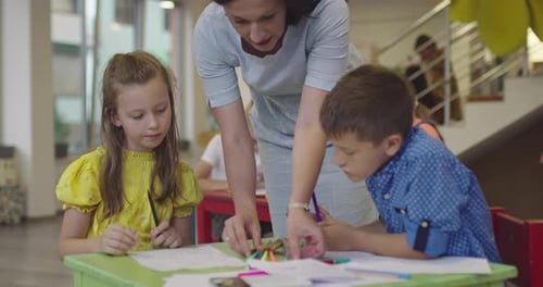 Creative Kids During an Art Class in a Daycare Center or Elementary School Classroom Drawing with