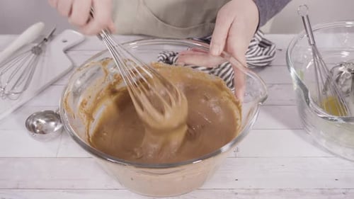 Brown Batter Being Mixed in Glass Bowl