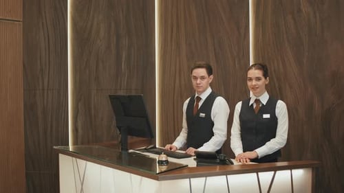 Portrait of Hotel Workers at Reception Desk