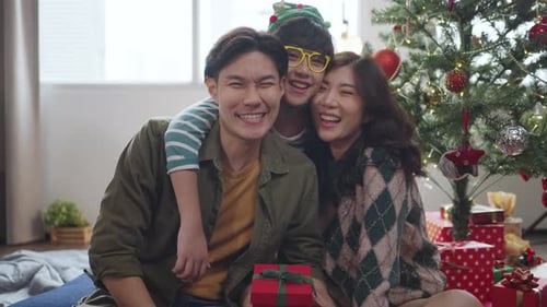 Smiling Family Celebrates Christmas at Home