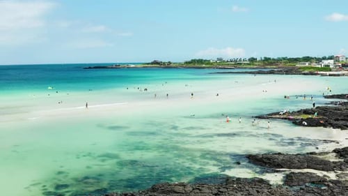 People who enjoy swimming and the clear blue sea of Jeju Island.