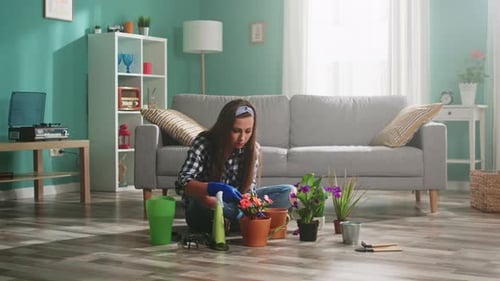 Girl Gardening with Potted Plants Indoors