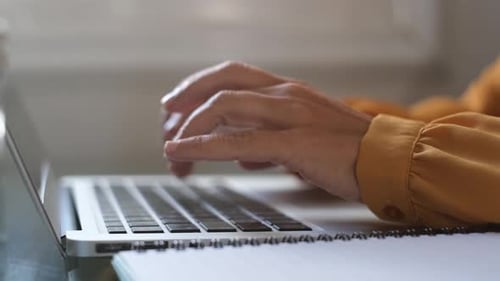 Close Up of Adult Hands Typing on Laptop