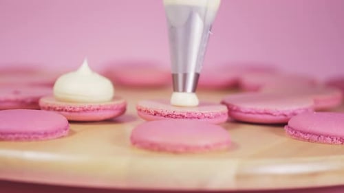 Beautiful Pink Macaroons on Fill with Light Cream on a Pink Background