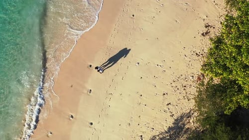 Tropical sandy beach Bahamas. Young couple walking on the soft sand enjoying honeymoon vacation. Foa