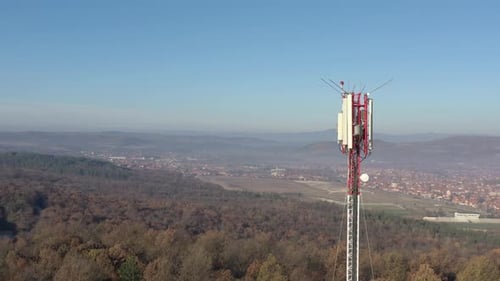Telecommunication tower above endless valley 4K drone footage