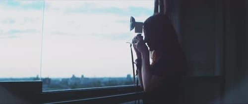 Woman with Vintage Camera at City Window