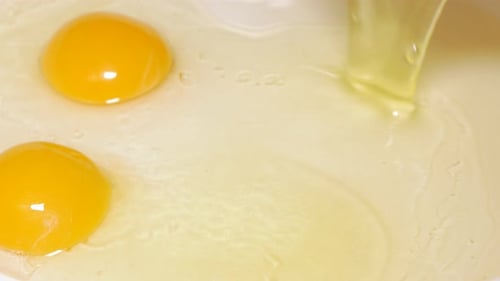 Raw Egg Yolks in Bowl, Close Up
