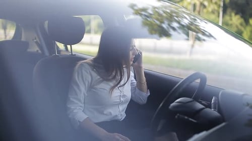 Woman Talking on Phone in Car