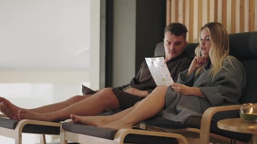 Lounge Zone of Modern Family Spa Center Adult Man and Woman are Relaxing in Chaises and Resting