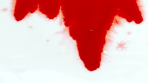 Red Paint Spreads on a White Surface