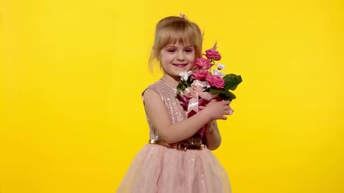 Happy Young Girl Holding Flowers Against Yellow Background