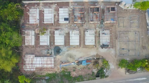 Aerial top view of homes or houses in village under construction site with structure. Top view