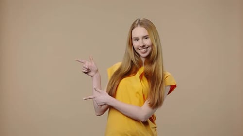 Smiling Woman Points and Gives Thumbs Up