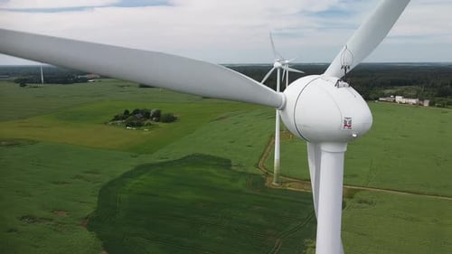 Wind Turbines Turning in Green Rural Landscape