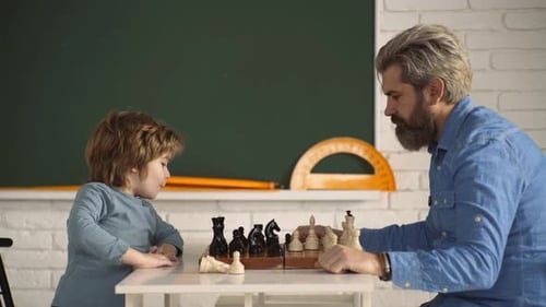Bearded Man Playing Chess With a Child