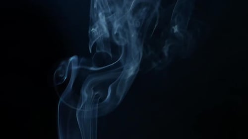 Wispy Blue Smoke Rising Against Black Background