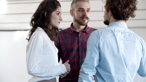 Teamwork: Colleagues Engaging in Lively Office Conversation