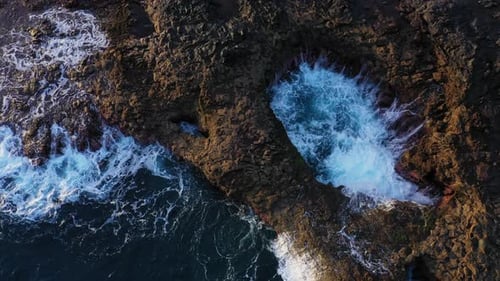 Sea Flowing Into Rock Pool And Against Coastline