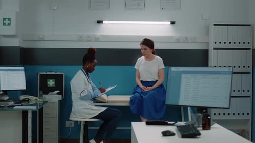 Doctor Consults Patient in Bright Medical Office