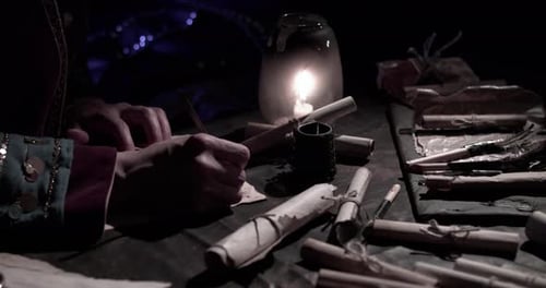 Person Writing With Quill by Candlelight