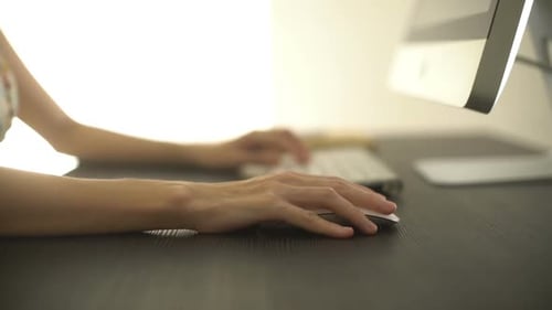 Close Up Hands Using Computer Mouse At Desk