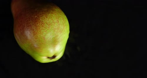 One Ripe Pear Is Rotated on the Table.