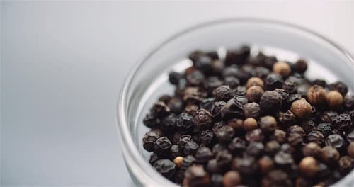 Close Up of Black Peppercorns in Bowl