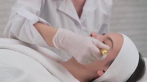 Close Up of Beautician Hands Doing Facial Massage for Client