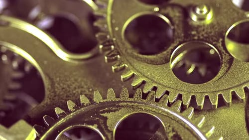 Gears Turning in a Gold Mechanism Macro Shot