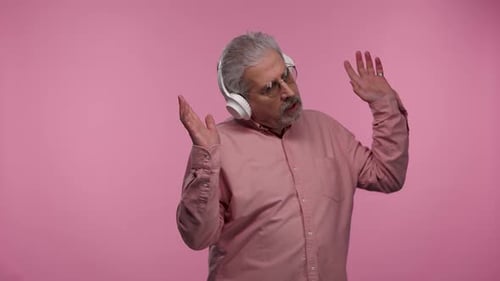 Senior Man Dancing and Listening to Music
