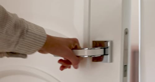 Hand Opens Modern Interior Door