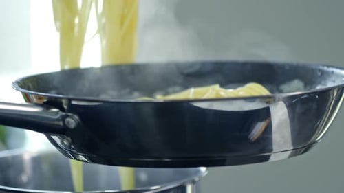 Pasta Cooked and Tossed in Pan on Stove