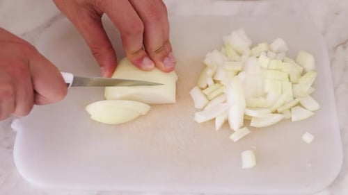 Dicing an Onion with a Knife on Board