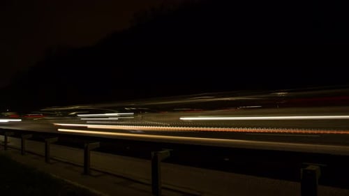 Fast movement of cars on the road at night, headlights, blurry lights