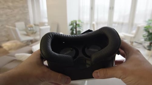 Holding a VR Headset in a Modern Living Room