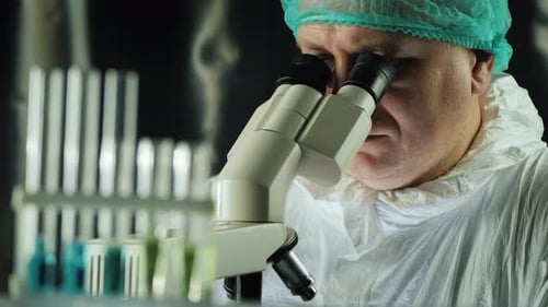 Reagent Test Tubes in the Lab, in the Background a Man Works with a Microscope