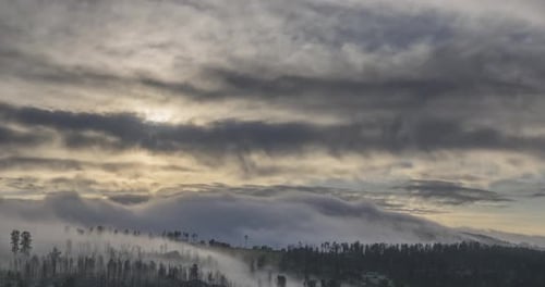 Fog and Clouds Rolling Over Rural Mountains